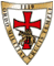 Das rote Kreuz auf weißem Grund ist mit einem goldenen Rahmen umrandet mit dem lat. Namen des Ordens. Im Wappen vor dem Kreuz sitzen zwei Ritter auf einem Pferd.